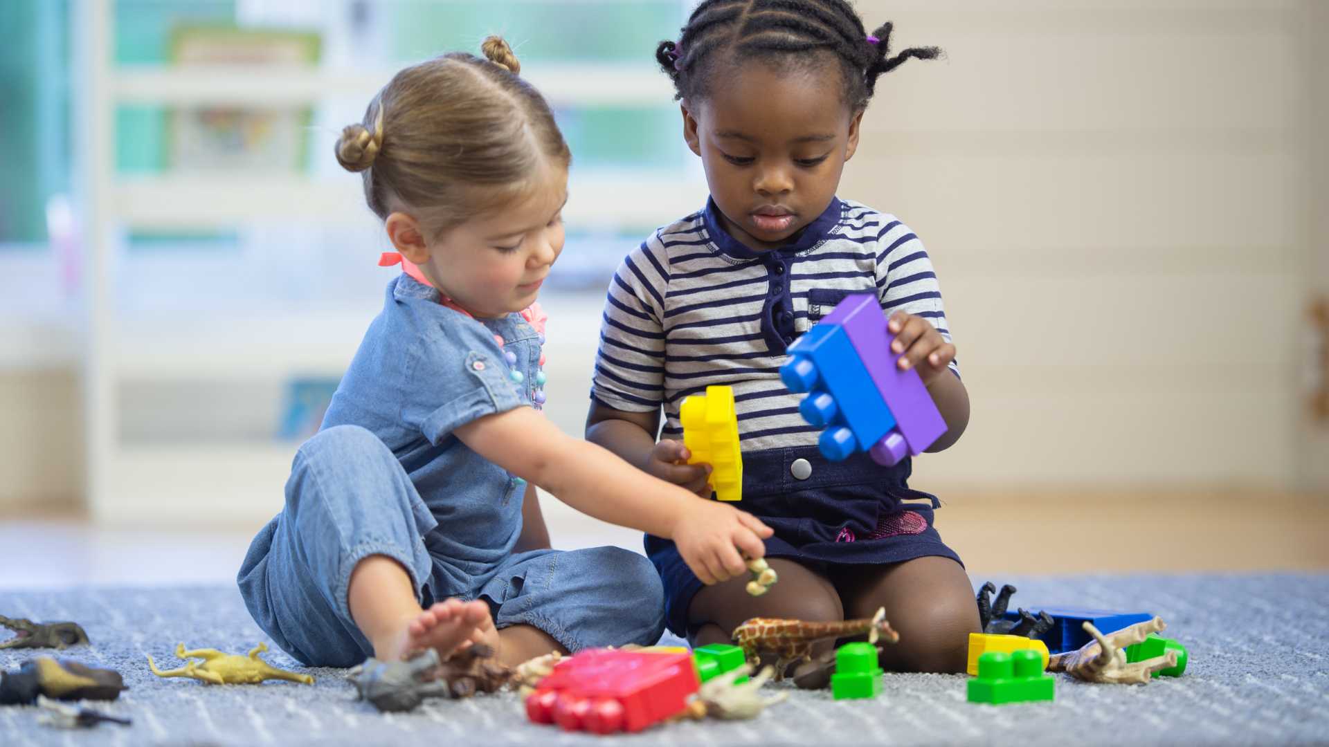 Child lacing beads with adult